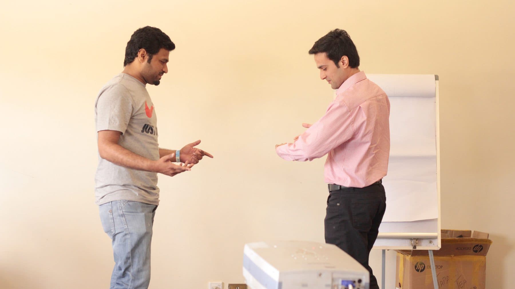 Two people in close conversation, standing, one listening hard